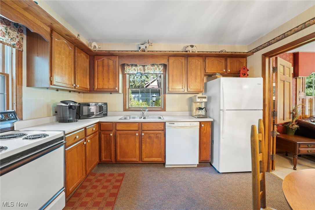 3602 Darrow Road Stow, OH 44224 - Photo 14 of 26 Kitchen featuring white appliances, sink and carpet
