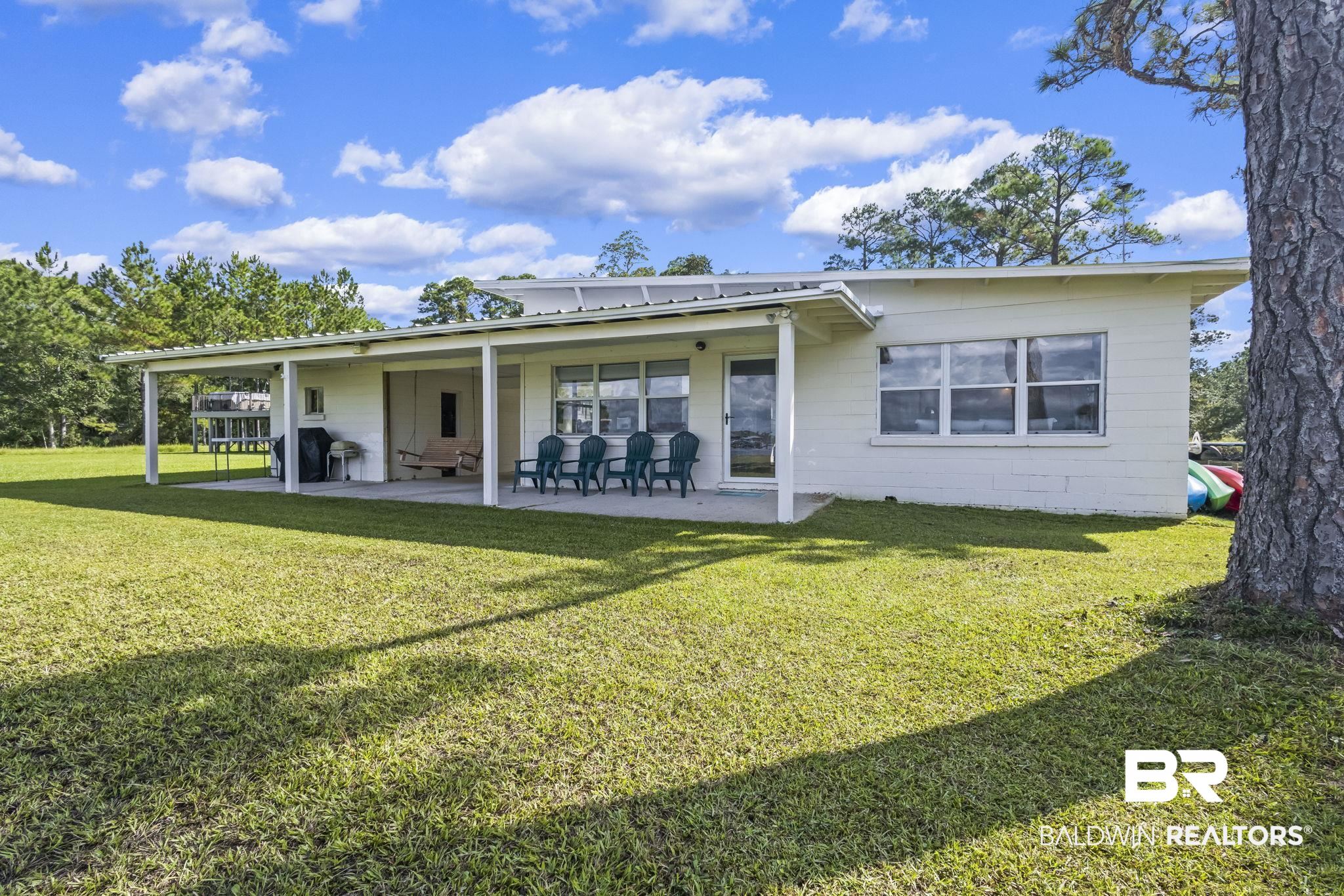 7849 Bayshore Drive Elberta, AL 36530 - Photo 40 of 47 Back of house with a yard and a patio area