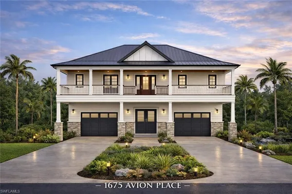 a front view of a house with a garden and garage
