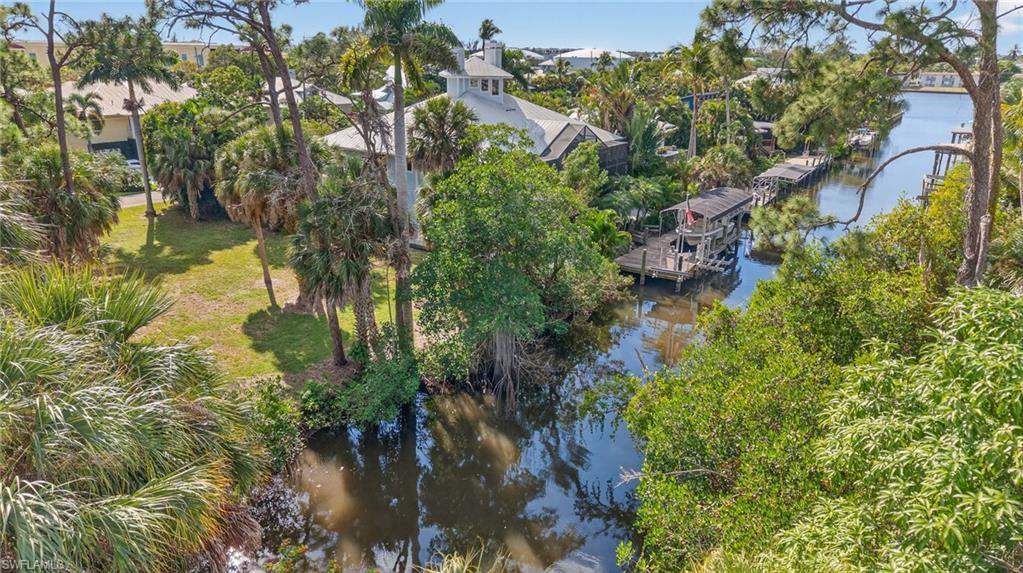 1675 Avion Place Naples, FL 34104 - Photo 11 of 16 a view of a lake with large trees