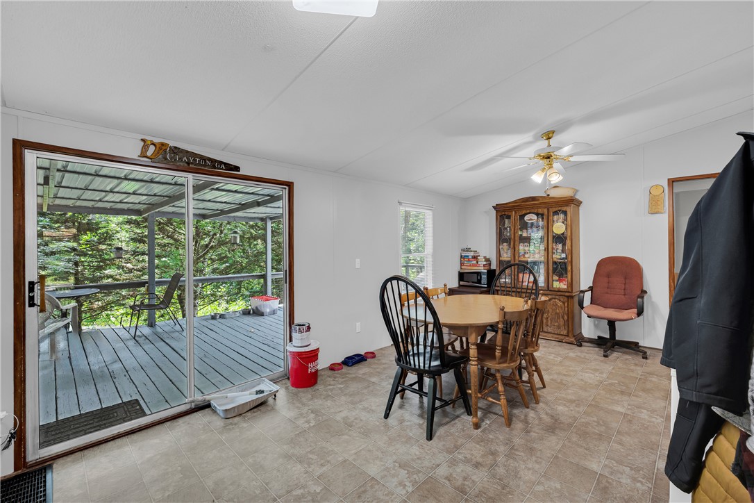 162 Newberry Road Walhalla, SC 29691 - Photo 8 of 50 Step into a comfortable dining space featuring durable tiled floors and direct access to an outdoor screened porch.