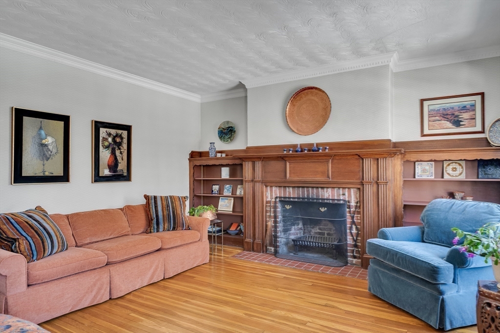 48 Avondale Road Newton, MA 02459 - Photo 25 of 37 a living room with furniture a fireplace and a large window
