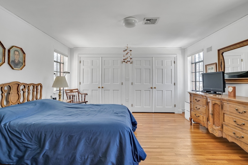 48 Avondale Road Newton, MA 02459 - Photo 28 of 37 a spacious bedroom with a bed and a flat tv screen on dresser