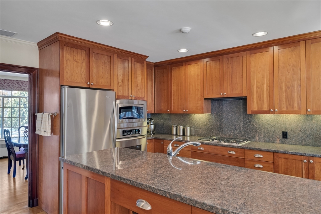 48 Avondale Road Newton, MA 02459 - Photo 3 of 37 a kitchen with granite countertop a refrigerator a stove a sink and a microwave