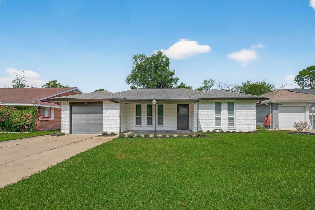 511 Bellmar Lane Friendswood, TX 77546 - Photo 1 of 29 a front view of a house with a garden and yard