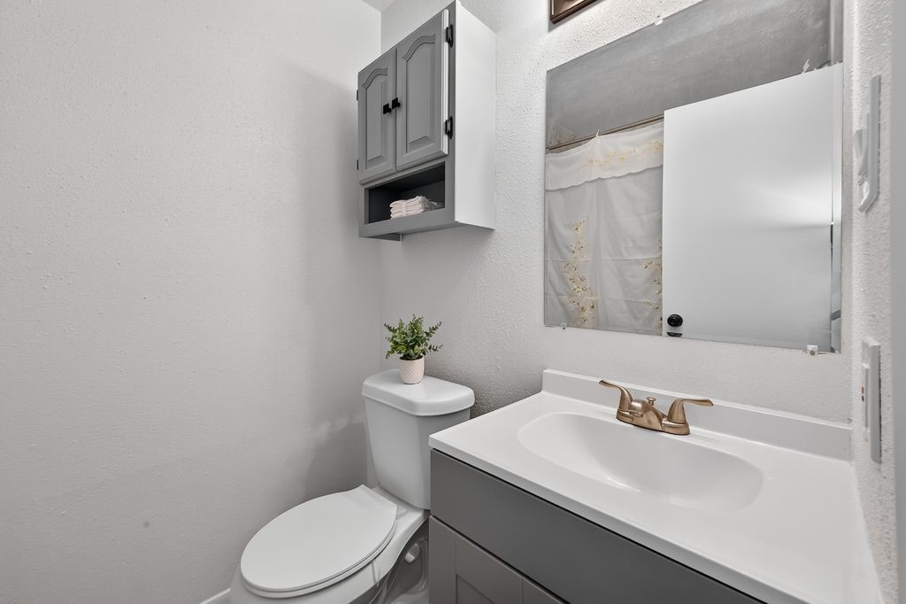 511 Bellmar Lane Friendswood, TX 77546 - Photo 15 of 29 a bathroom with a sink a toilet and mirror