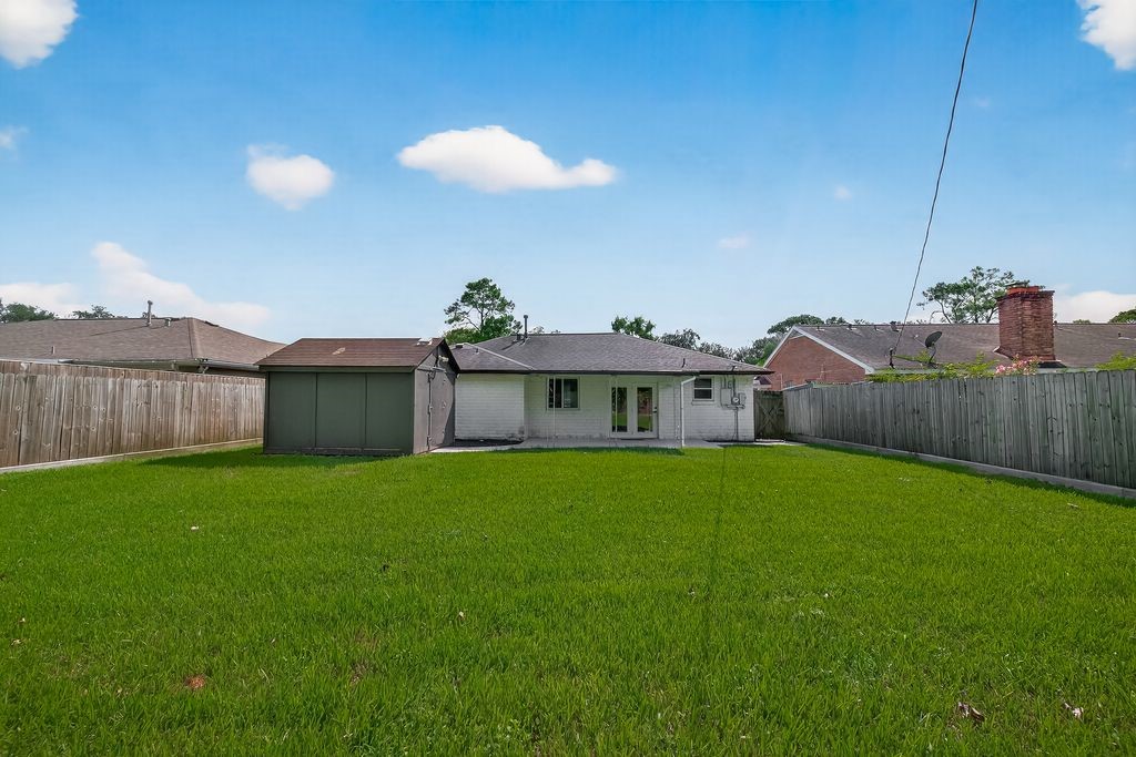 511 Bellmar Lane Friendswood, TX 77546 - Photo 24 of 29 a view of a house with backyard and garden