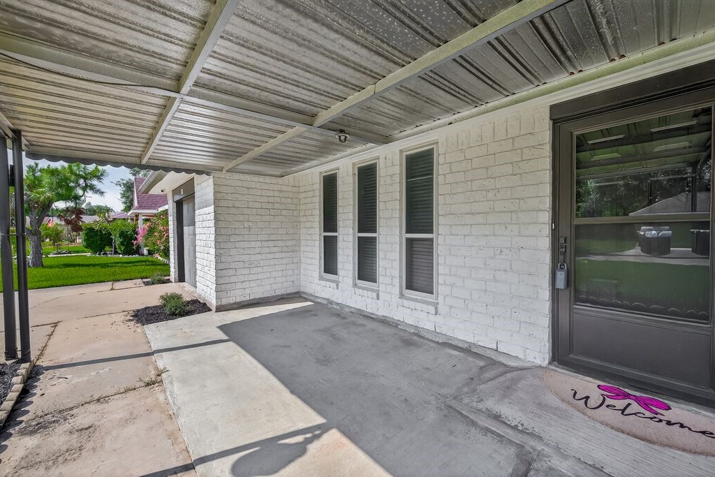 511 Bellmar Lane Friendswood, TX 77546 - Photo 4 of 29 a front view of a house with a yard and garage