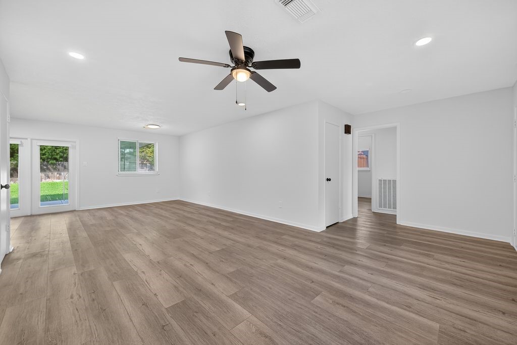 511 Bellmar Lane Friendswood, TX 77546 - Photo 6 of 29 a view of empty room with wooden floor and ceiling fan