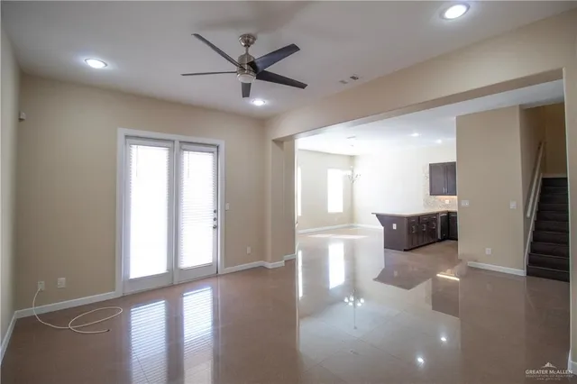 a view of a livingroom with a ceiling fan and window