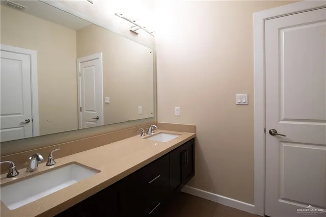 a bathroom with a sink double vanity and a mirror