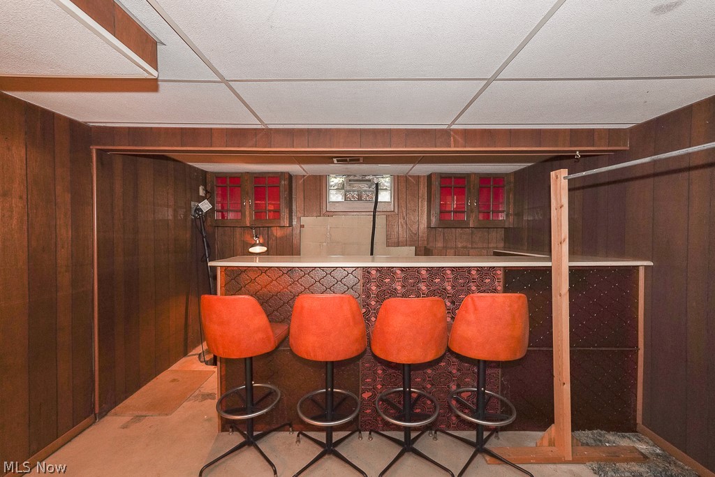 13028 Root Road Columbia Station, OH 44028 - Photo 29 of 35 Bar with a drop ceiling and wooden walls