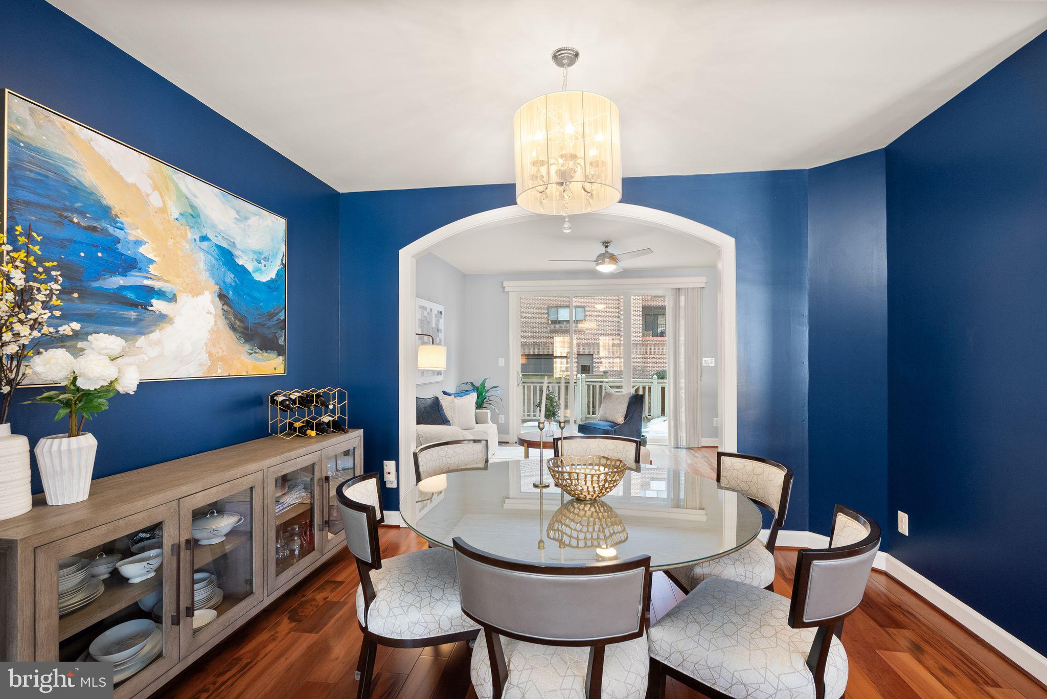 11477 Waterhaven Court Reston, VA 20190 - Photo 12 of 54 a view of a dining room with furniture a chandelier and wooden floor