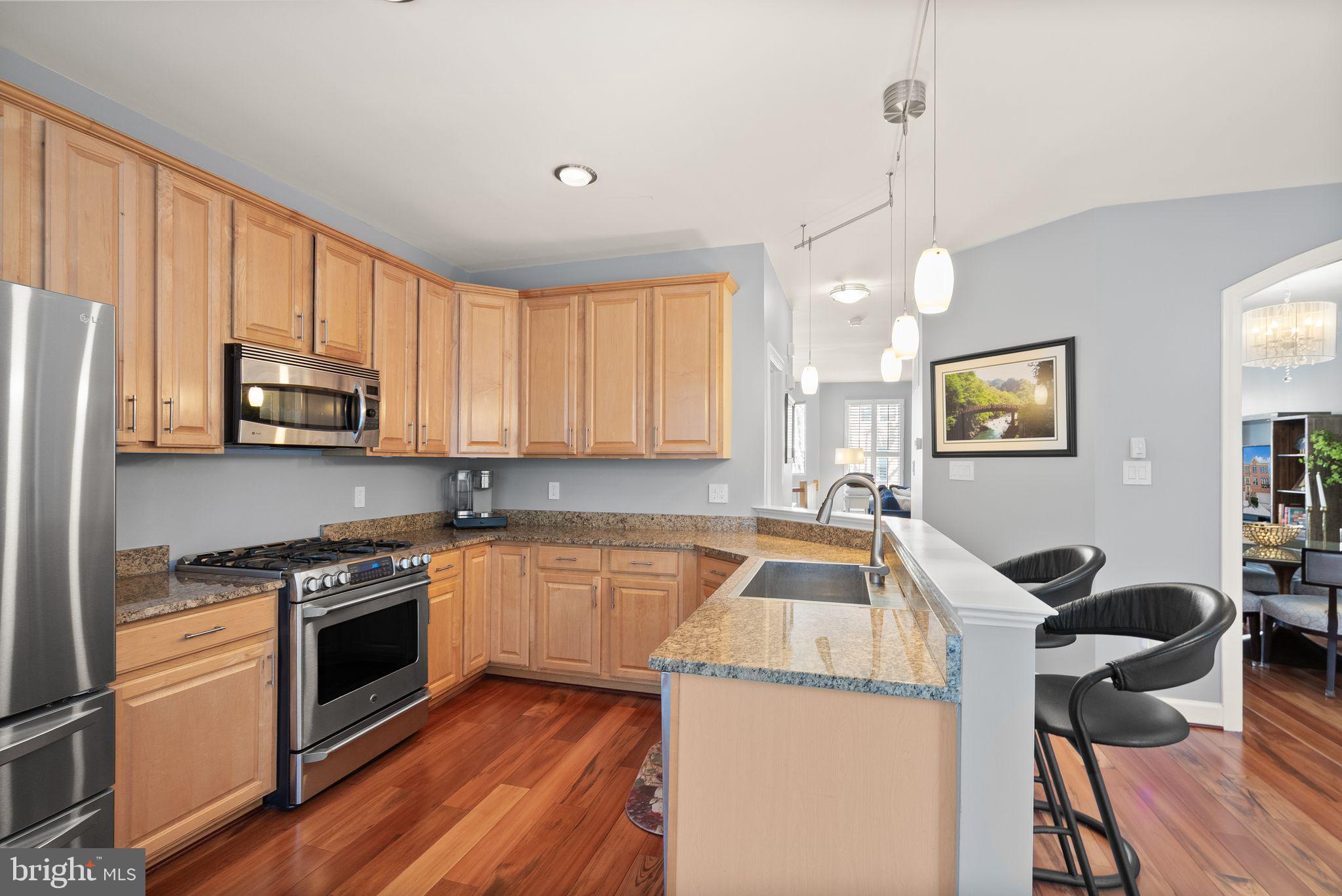 11477 Waterhaven Court Reston, VA 20190 - Photo 22 of 54 a kitchen that has a sink stainless steel appliances and cabinets