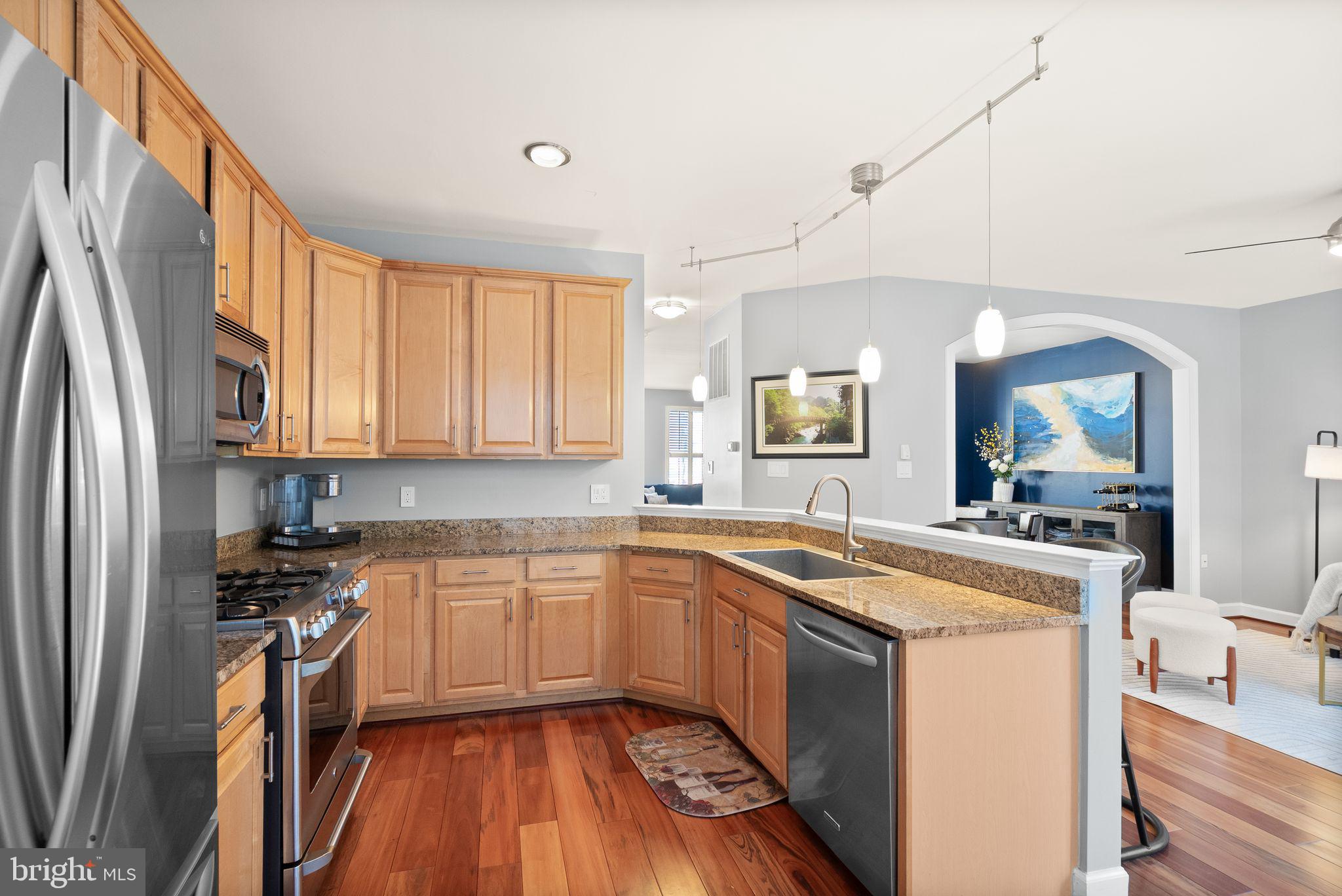 11477 Waterhaven Court Reston, VA 20190 - Photo 23 of 54 a kitchen with stainless steel appliances granite countertop a sink stove and refrigerator