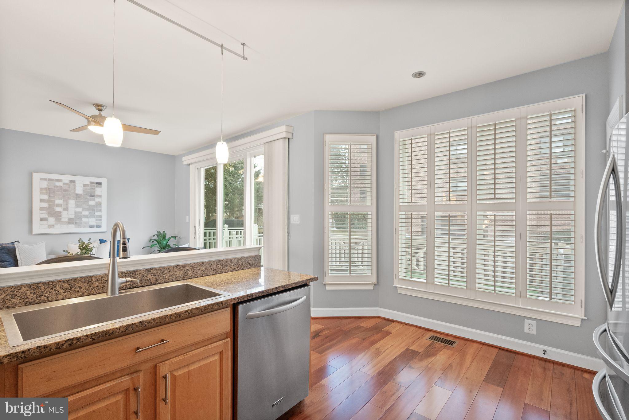 11477 Waterhaven Court Reston, VA 20190 - Photo 25 of 54 a view of a kitchen with a sink and wooden floor