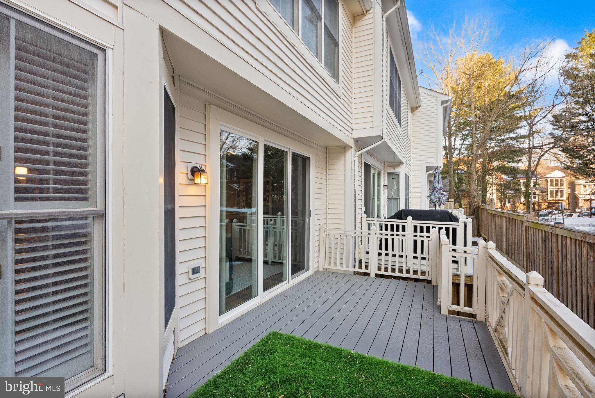 11477 Waterhaven Court Reston, VA 20190 - Photo 27 of 54 a view of a house with wooden deck and a yard