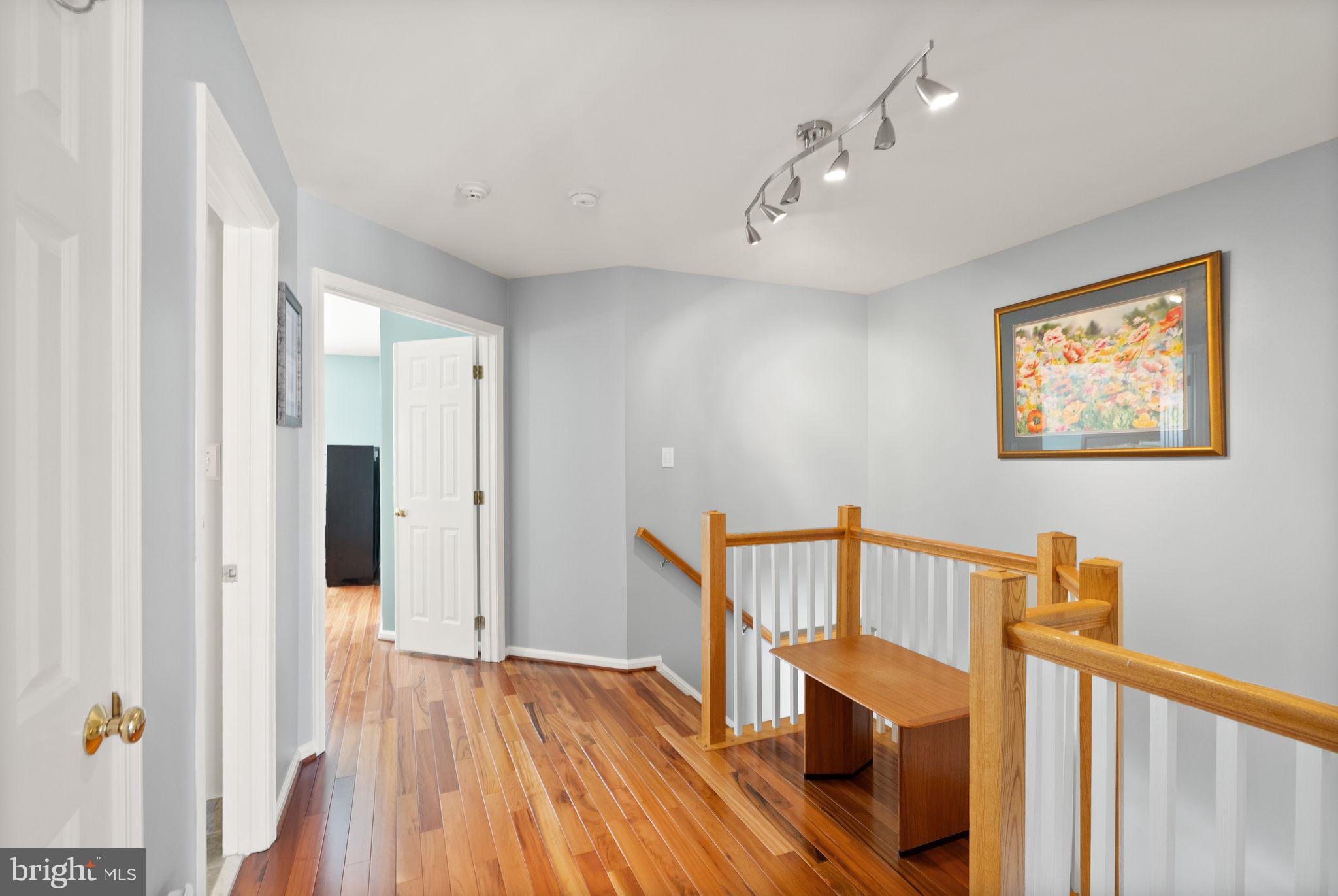 11477 Waterhaven Court Reston, VA 20190 - Photo 30 of 54 a view of a hallway with wooden floor and staircase