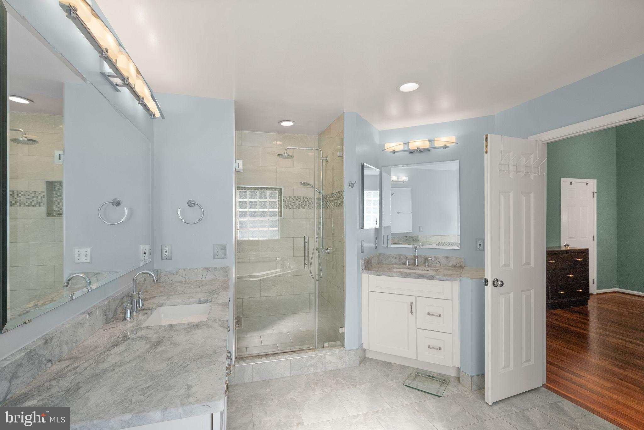 11477 Waterhaven Court Reston, VA 20190 - Photo 38 of 54 a bathroom with a granite countertop sink mirror and shower