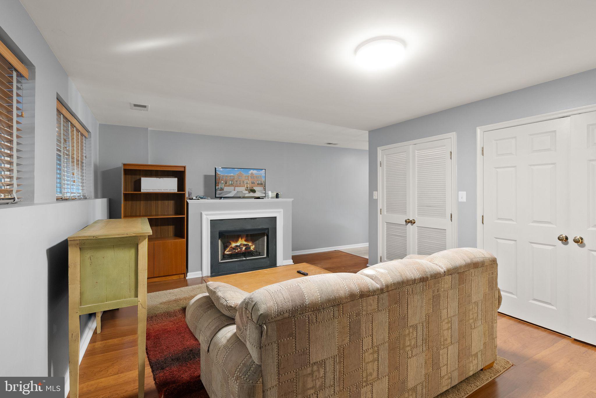 11477 Waterhaven Court Reston, VA 20190 - Photo 50 of 54 a living room with furniture and a fireplace