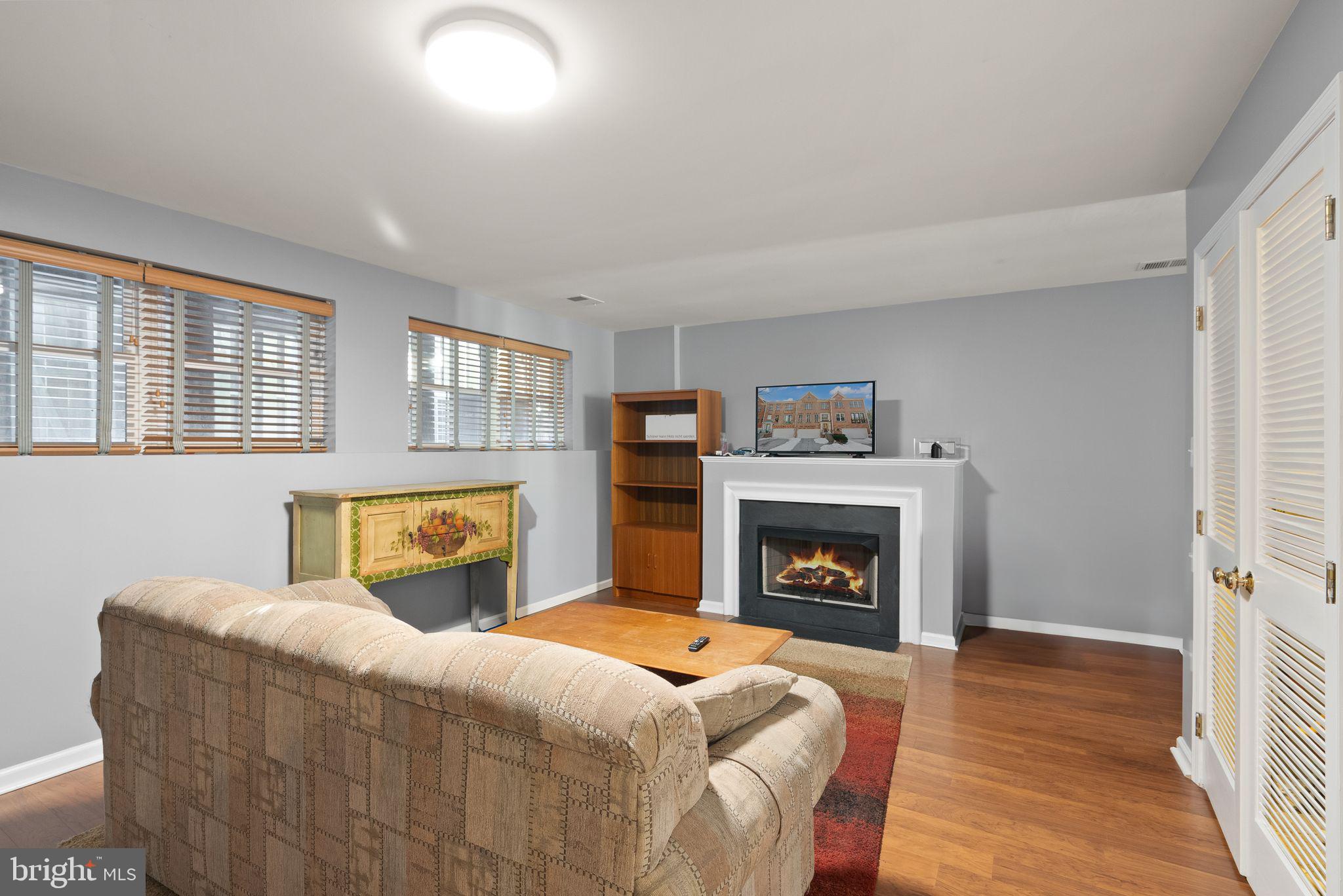 11477 Waterhaven Court Reston, VA 20190 - Photo 51 of 54 a living room with furniture and a fireplace