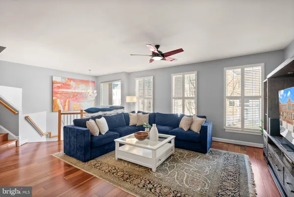 a view of a dining room with furniture a chandelier and wooden floor