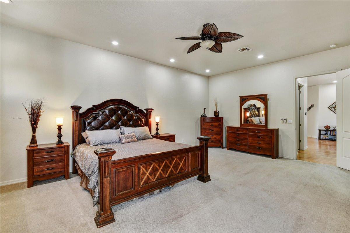 412 East Yearling Road Phoenix, AZ 85085 - Photo 17 of 51 a bedroom with a bed and a chandelier