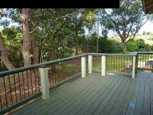 1454 Hog Back Road Haiku, HI 96708 - Photo 13 of 18 a view of a balcony with wooden floor and fence