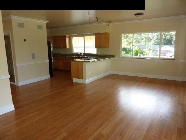 1454 Hog Back Road Haiku, HI 96708 - Photo 15 of 18 an empty room with wooden floor and a window