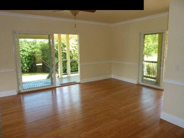 1454 Hog Back Road Haiku, HI 96708 - Photo 16 of 18 a view of empty room with wooden floor and fan