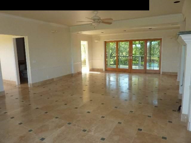 1454 Hog Back Road Haiku, HI 96708 - Photo 4 of 18 a view of empty room with wooden floor and fan