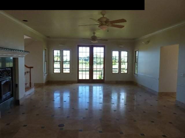 1454 Hog Back Road Haiku, HI 96708 - Photo 5 of 18 an empty room with wooden floor and windows