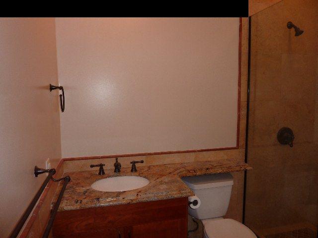1454 Hog Back Road Haiku, HI 96708 - Photo 8 of 18 a bathroom with a granite countertop toilet and a sink
