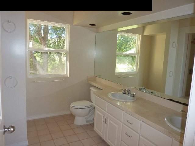 1454 Hog Back Road Haiku, HI 96708 - Photo 9 of 18 a bathroom with a granite countertop sink toilet and mirror