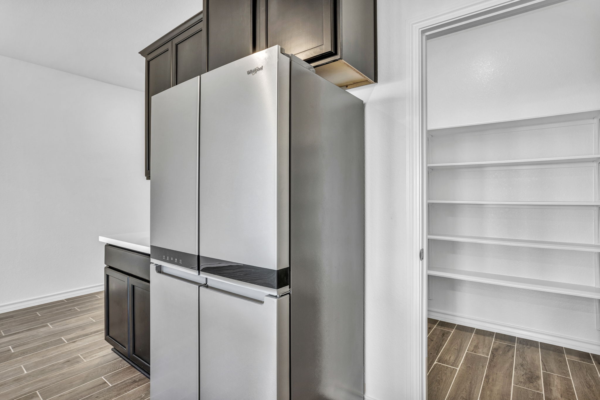 131 Adeline Road Hutto, TX 78634 - Photo 27 of 30 A well-appointed kitchen corner showcases sleek stainless steel appliances and convenient pantry storage.