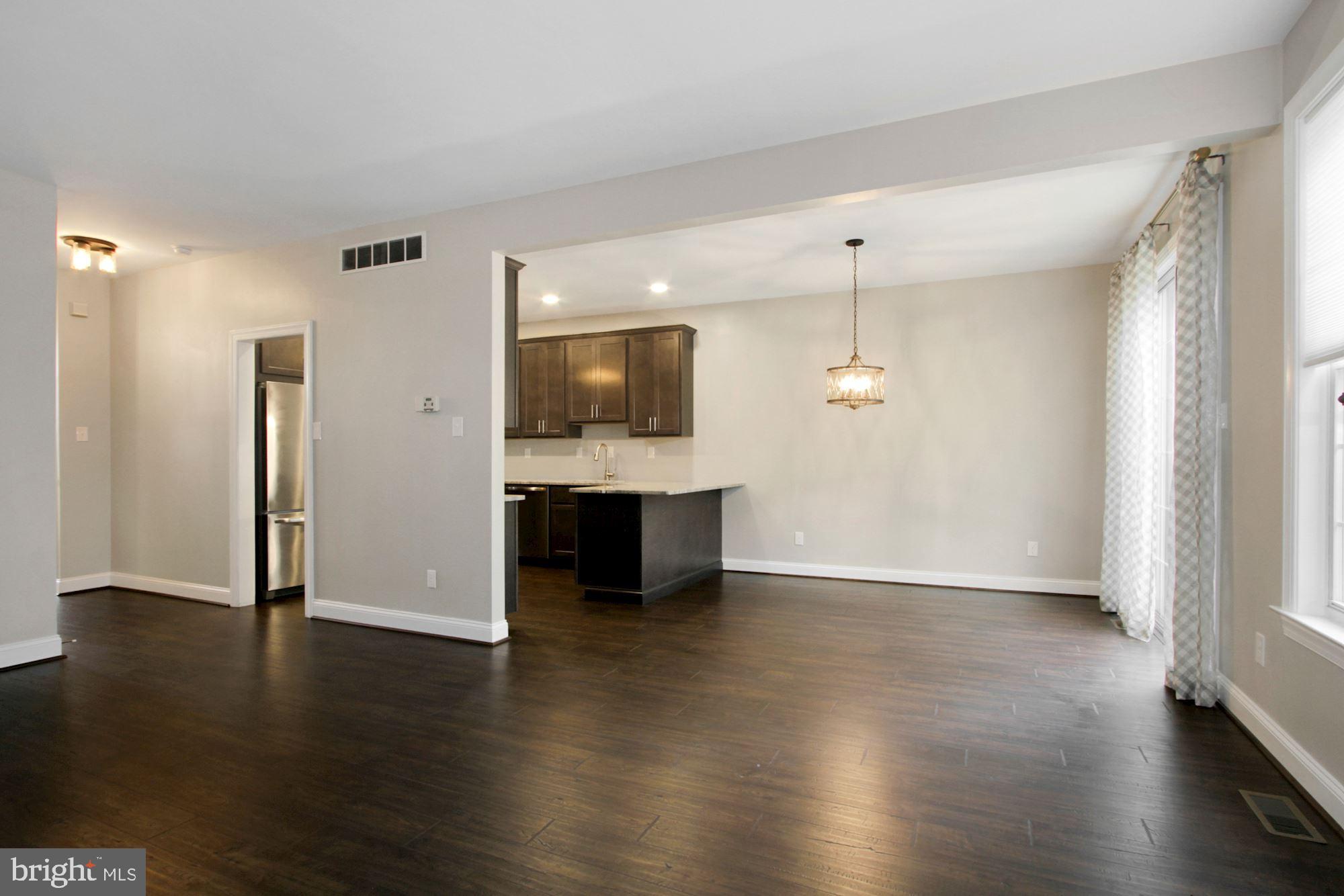 112 Federal Walk Kennett Square, PA 19348 - Photo 16 of 51 a view of a kitchen with a fridge and wooden floor