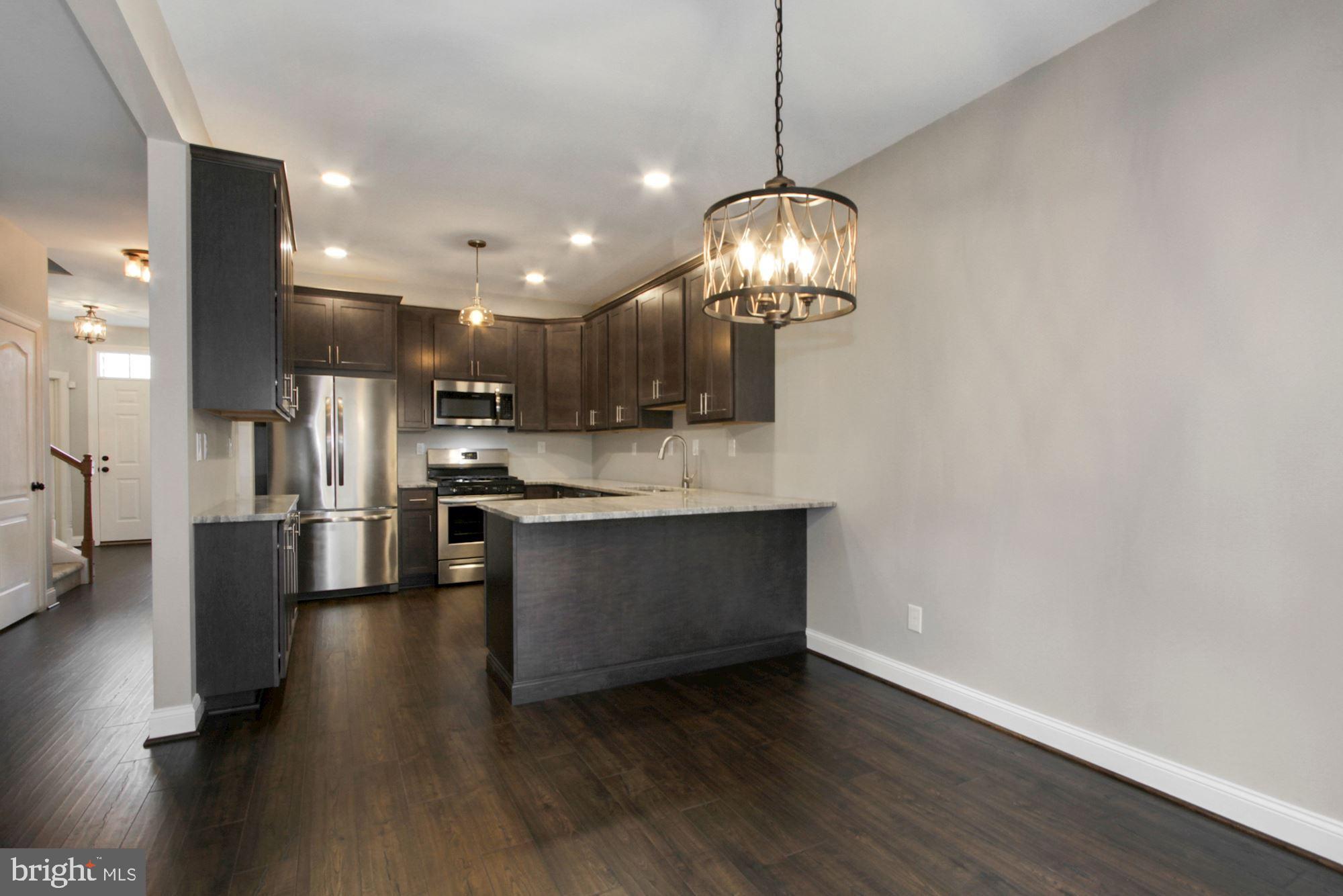 112 Federal Walk Kennett Square, PA 19348 - Photo 18 of 51 a view of large kitchen with refrigerator and wooden floor