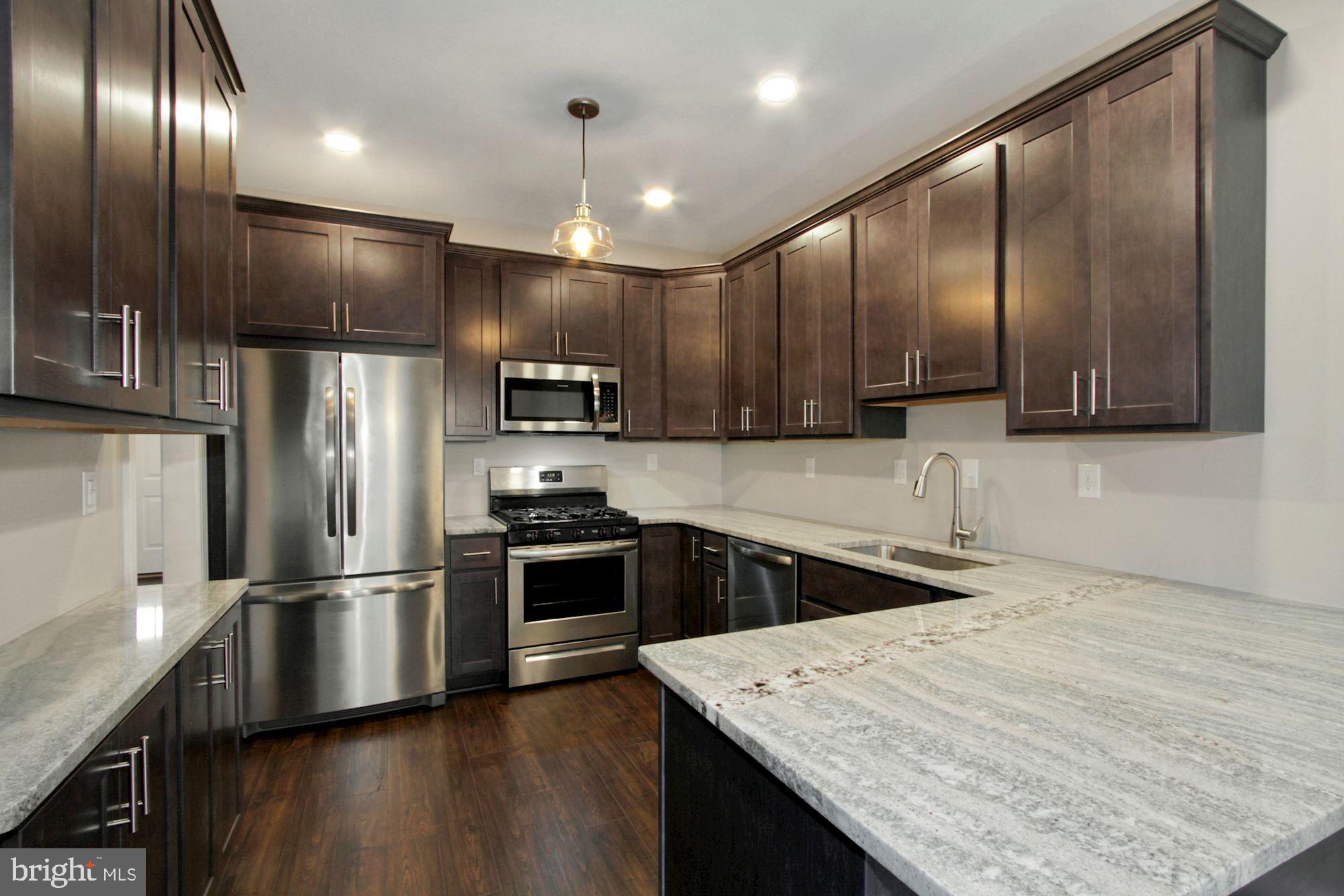 112 Federal Walk Kennett Square, PA 19348 - Photo 21 of 51 a kitchen with kitchen island granite countertop stainless steel appliances cabinets a sink and a center island