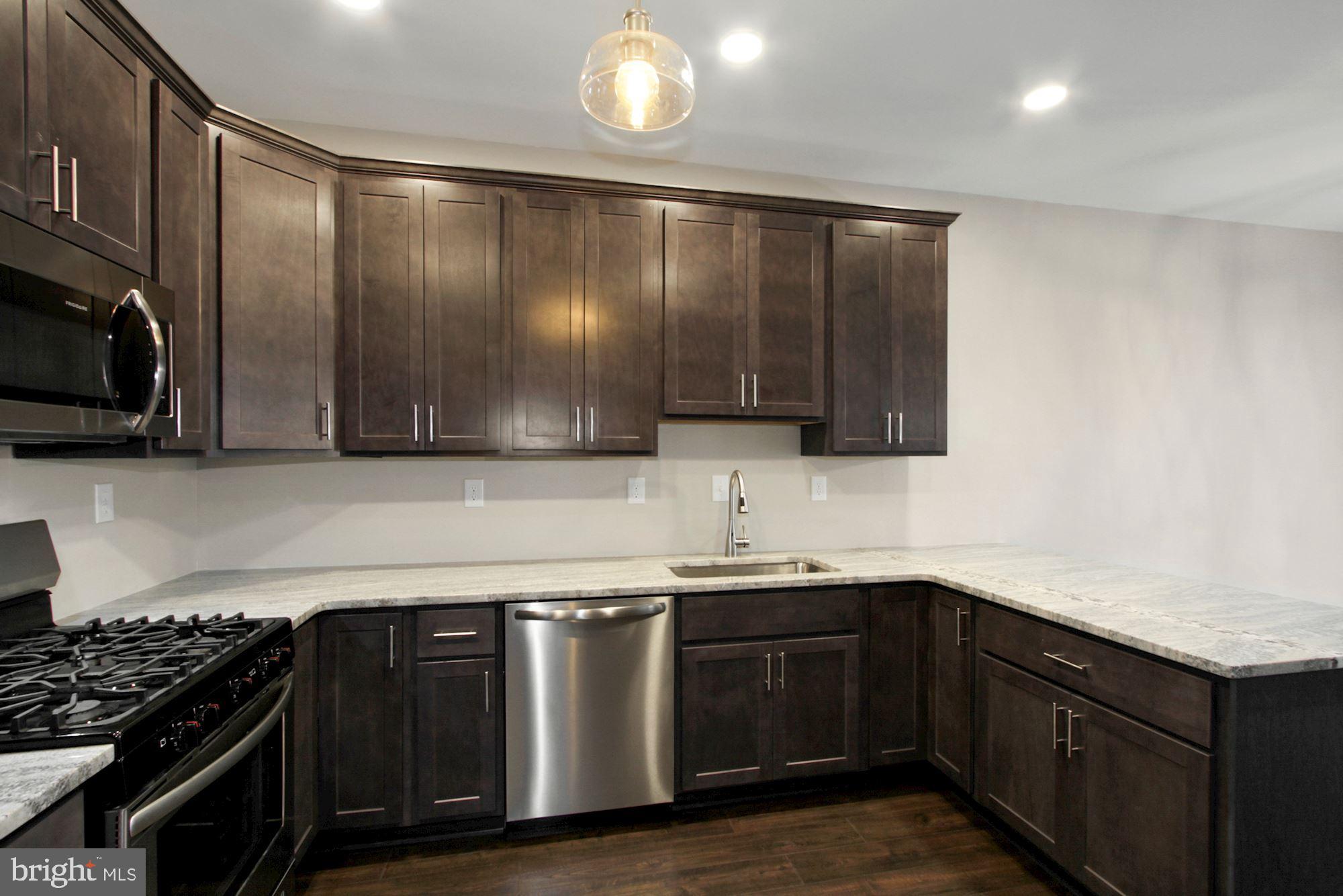 112 Federal Walk Kennett Square, PA 19348 - Photo 22 of 51 a kitchen with stainless steel appliances granite countertop a sink stove and cabinets