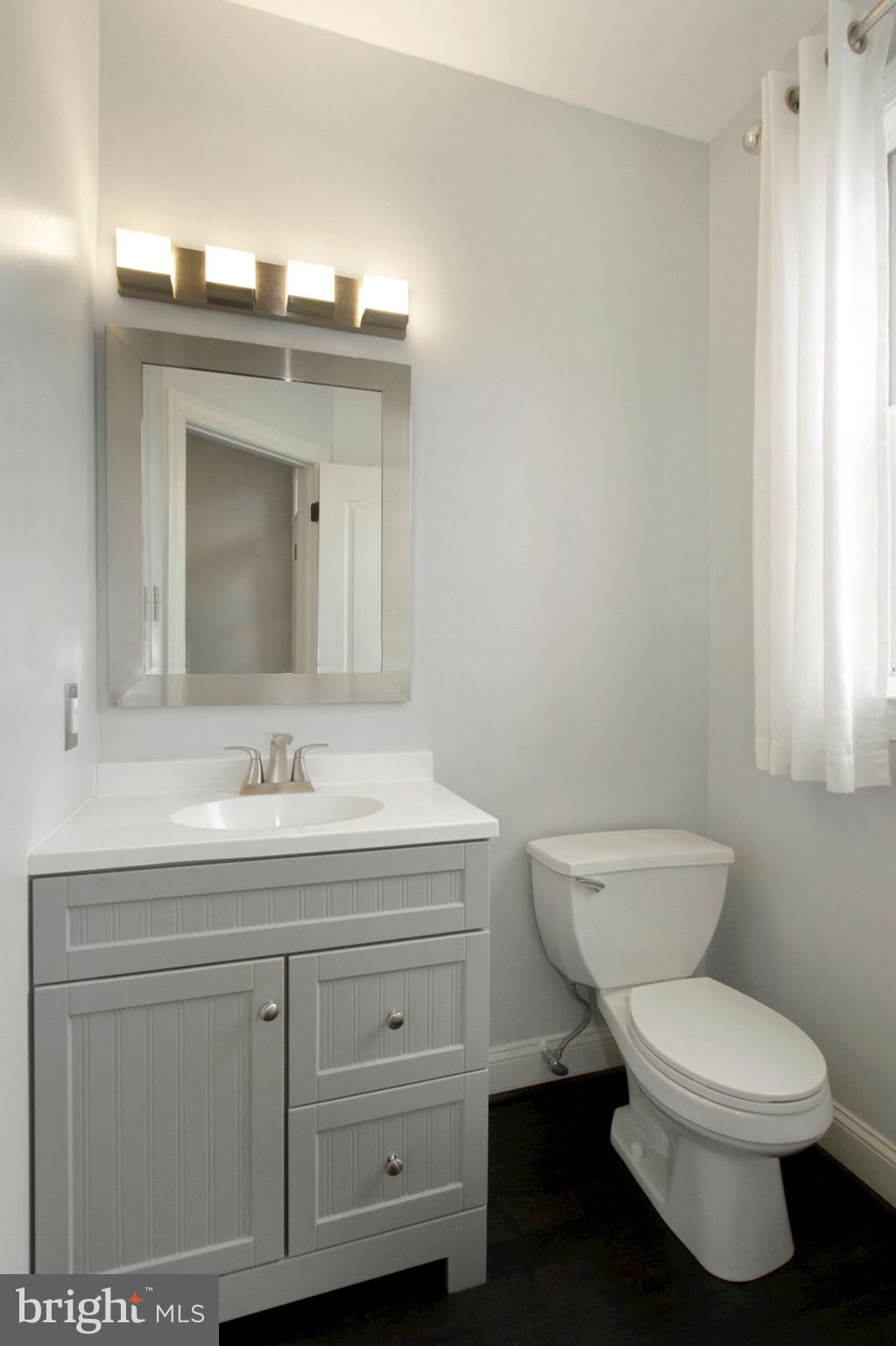 112 Federal Walk Kennett Square, PA 19348 - Photo 9 of 51 a bathroom with a toilet a sink and mirror