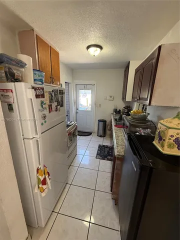a kitchen with a sink a stove and refrigerator