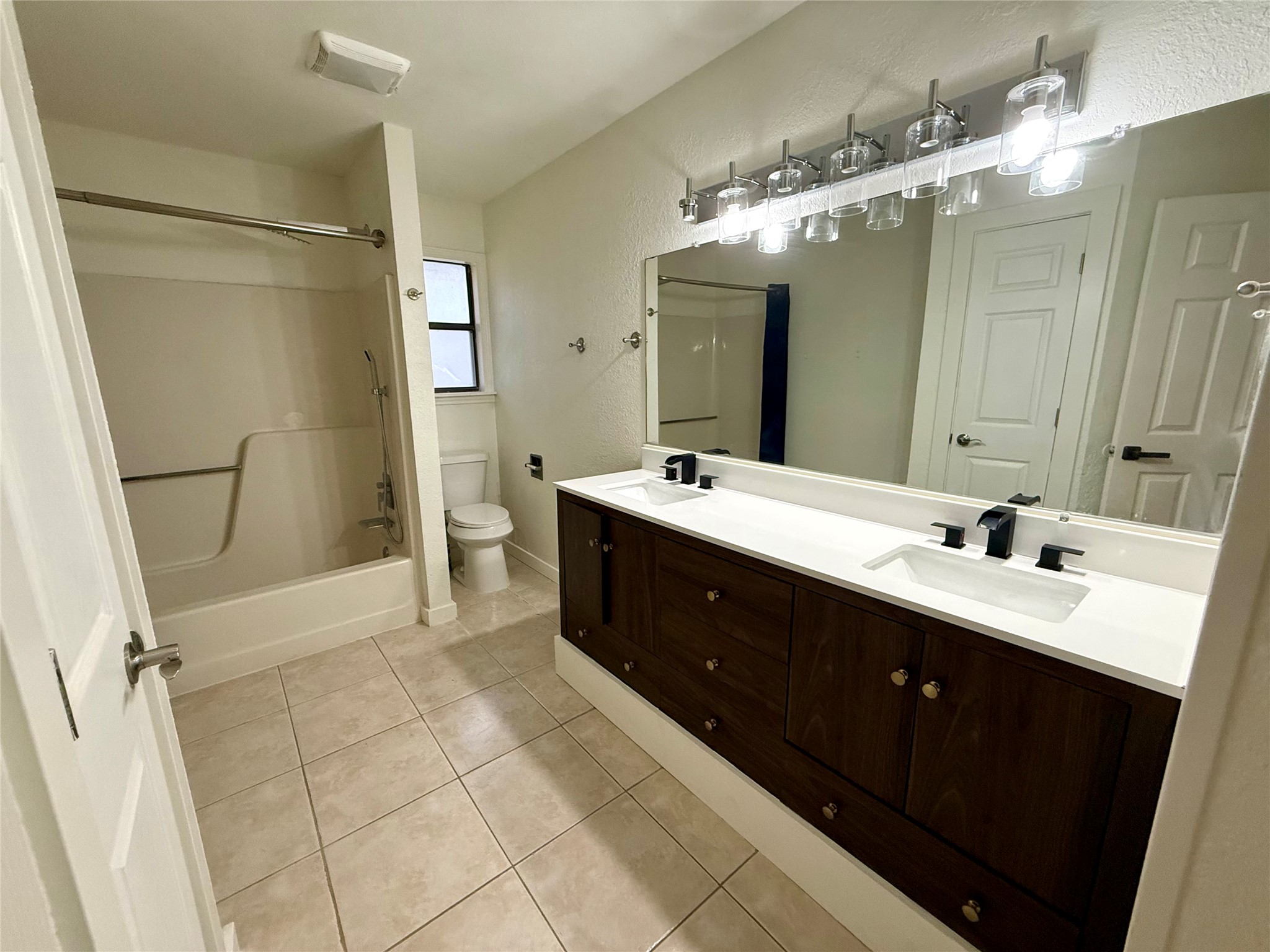 21003 Boggy Ford Road, Unit A Lago Vista, TX 78645 - Photo 12 of 19 a spacious bathroom with a double vanity sink mirror double and shower