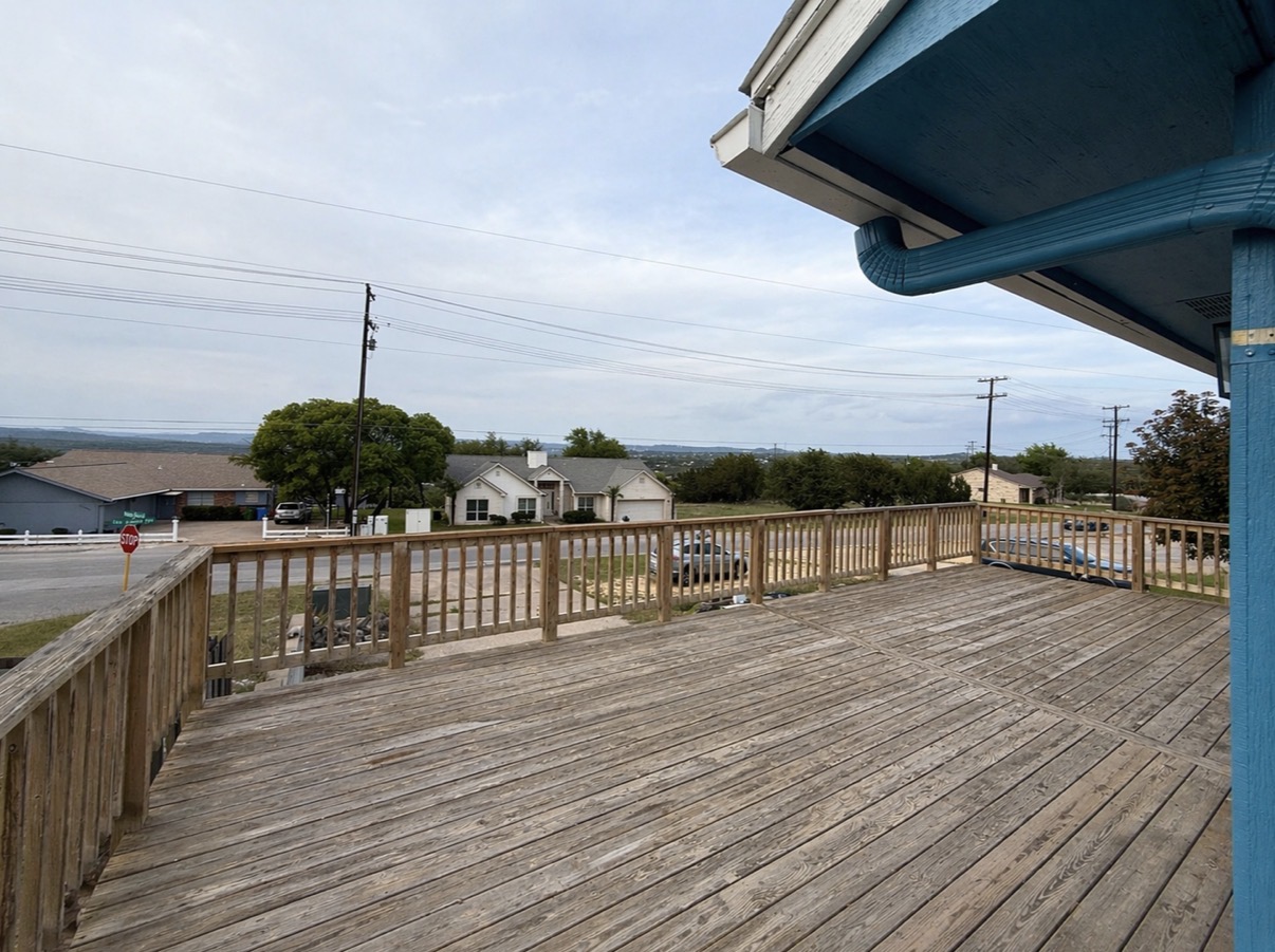 21003 Boggy Ford Road, Unit A Lago Vista, TX 78645 - Photo 18 of 19 a view of a balcony with wooden floor