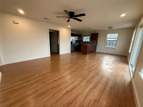 a view of a work space with wooden floor and a ceiling fan
