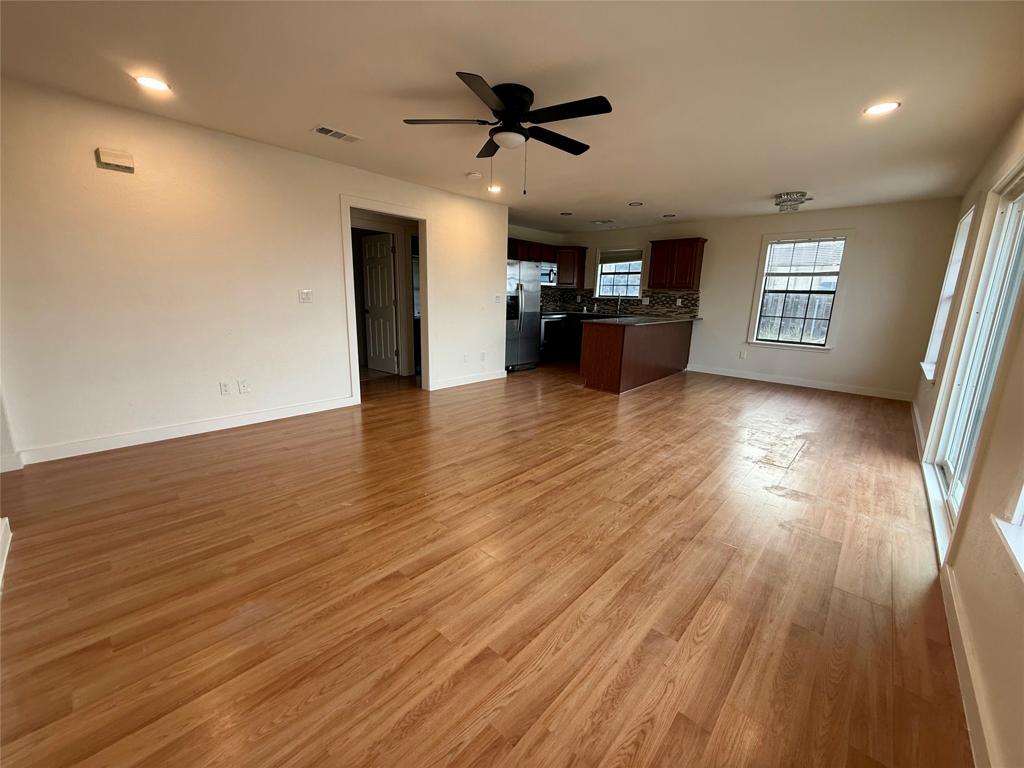 21003 Boggy Ford Road, Unit A Lago Vista, TX 78645 - Photo 4 of 19 a view of a work space with wooden floor and a ceiling fan