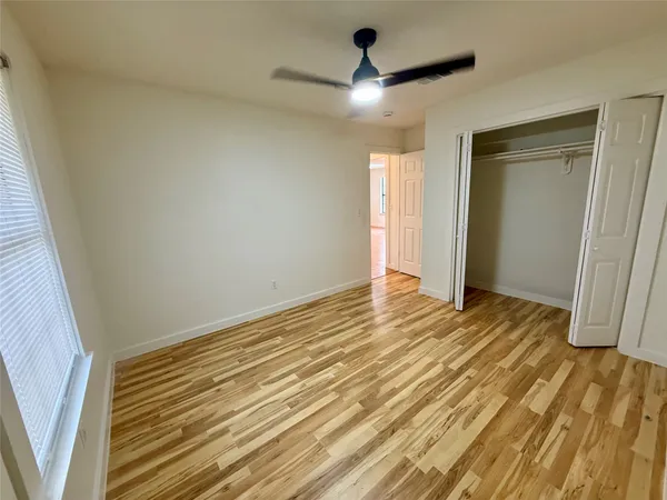 a view of an empty room and wooden floor