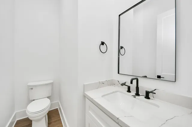 a bathroom with a sink toilet and mirror