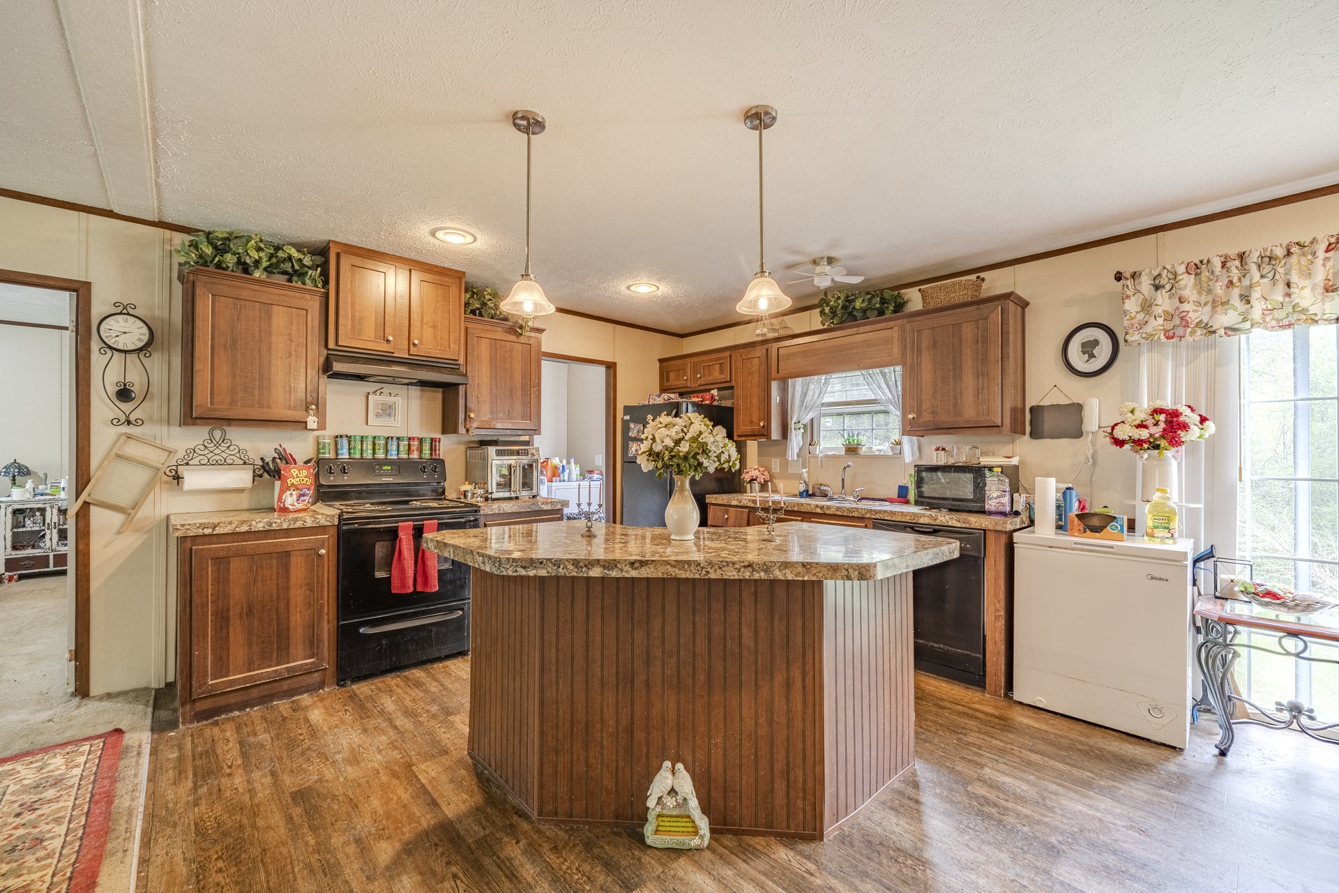 4242 Upper Factory Creek Road Waynesboro, TN 38485 - Photo 12 of 30 a open kitchen with stainless steel appliances granite countertop a stove and refrigerator