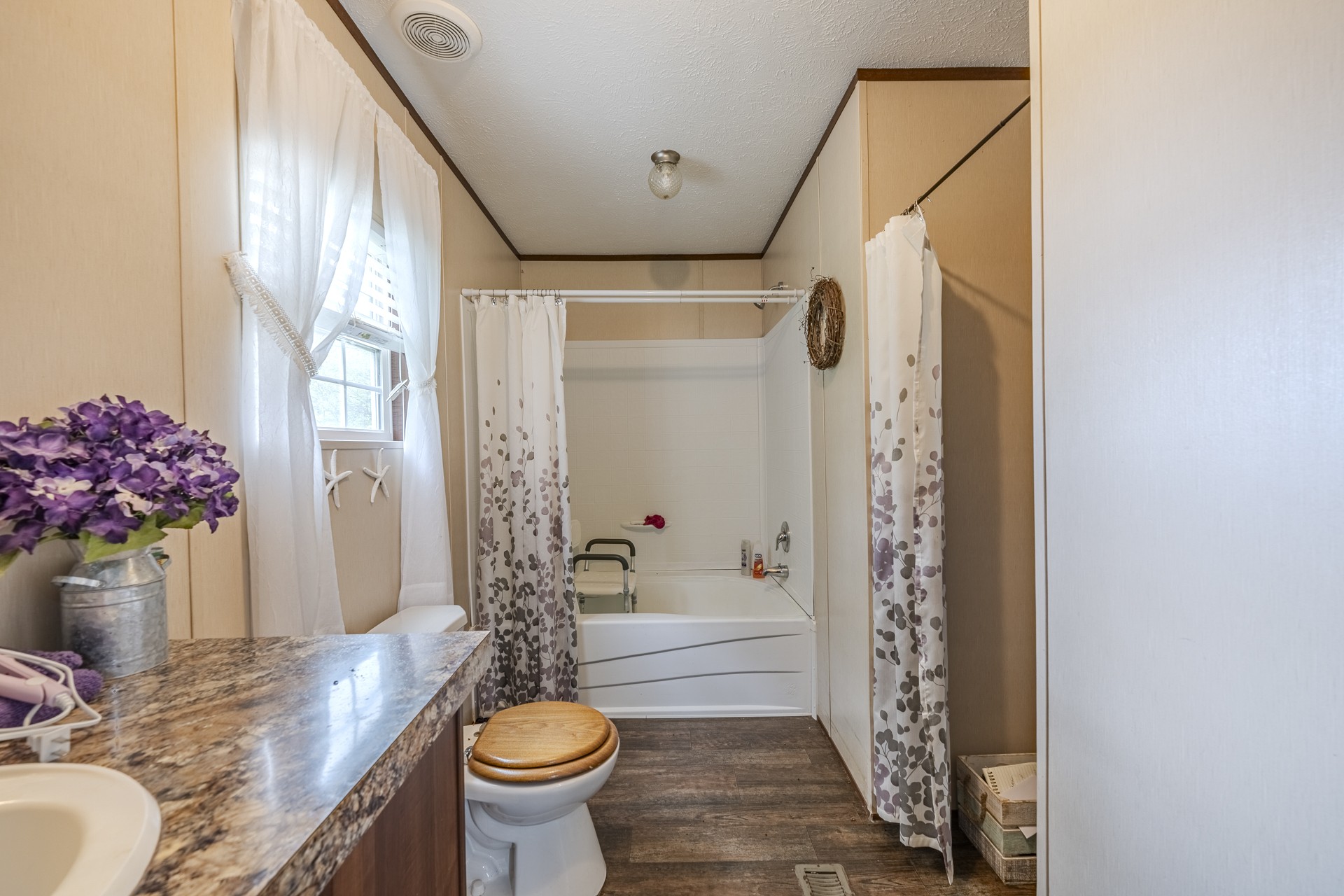 4242 Upper Factory Creek Road Waynesboro, TN 38485 - Photo 16 of 30 a bathroom with a granite countertop sink a toilet and shower