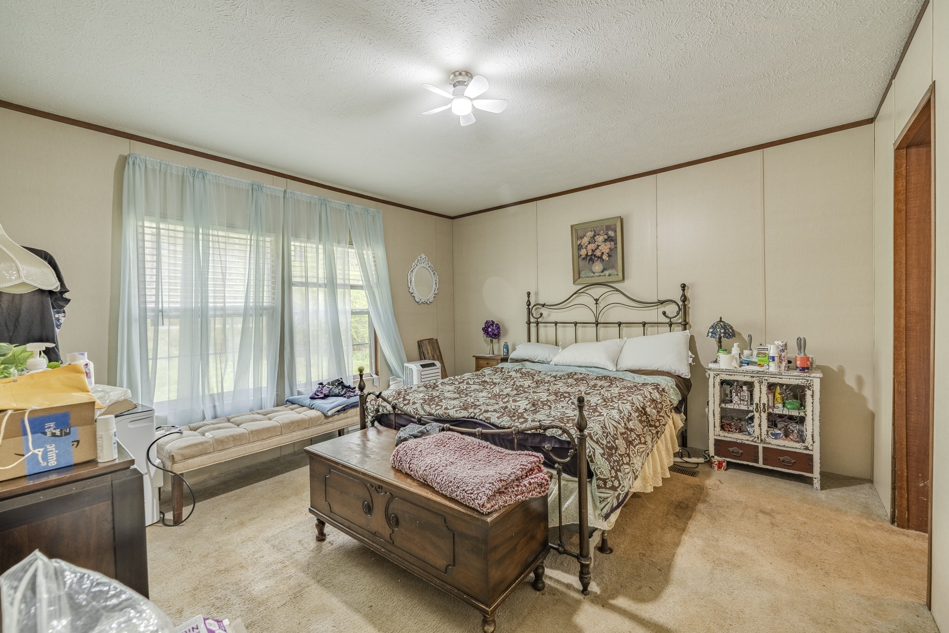 4242 Upper Factory Creek Road Waynesboro, TN 38485 - Photo 17 of 30 a bedroom with a bed and a chandelier